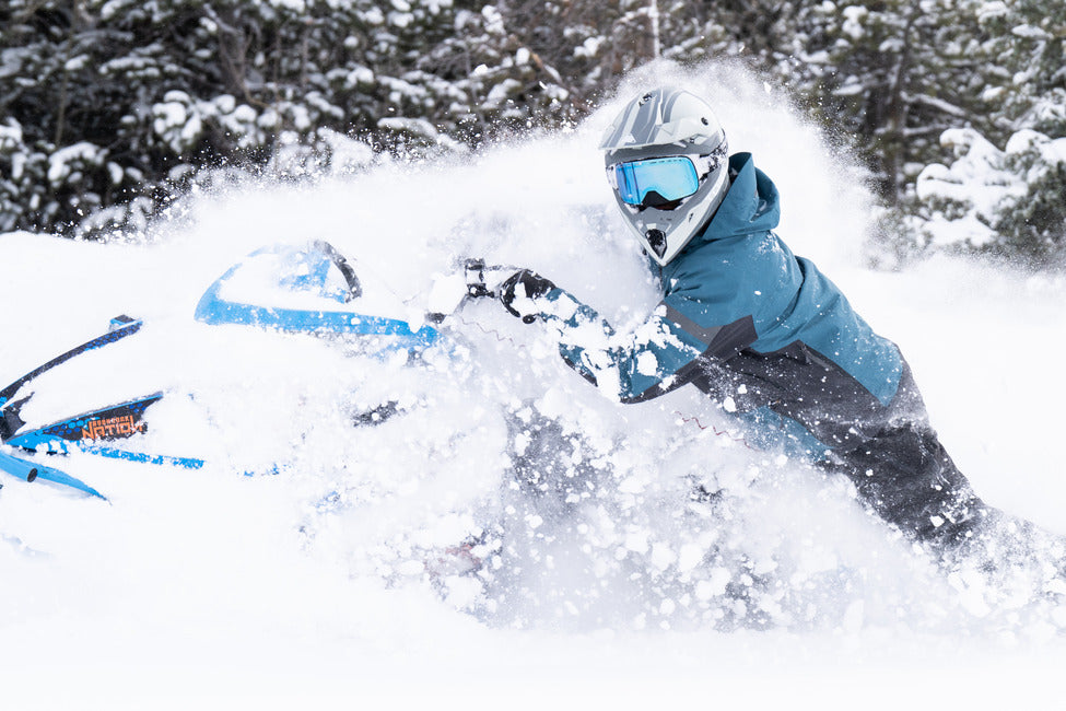 TOBE Snowmobiling Goggles on snowmobiler in snow